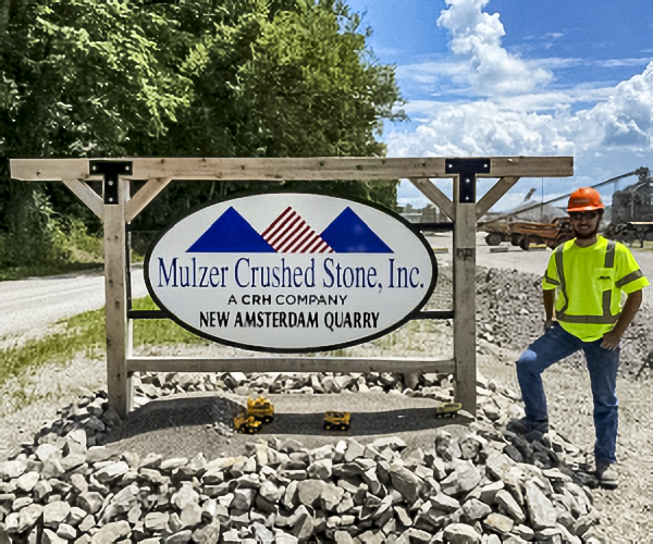 Intern in front of Mulzer Sign