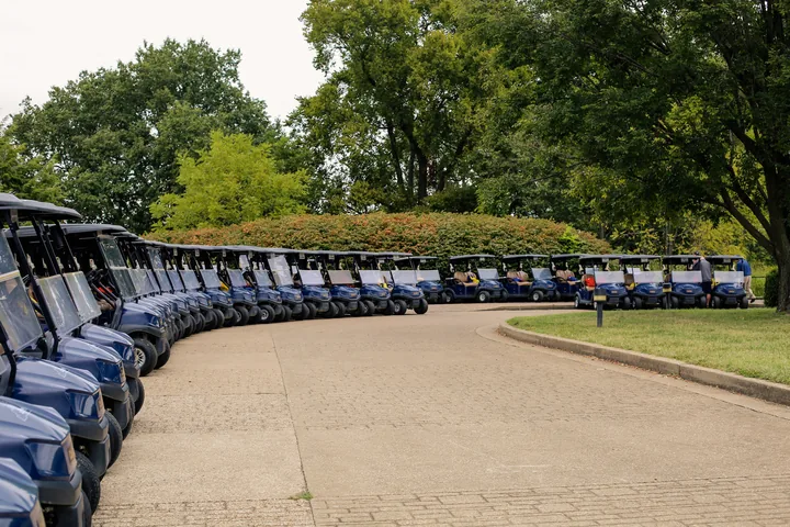 Rows of blue golf carts ready for participants at The Pearl Club.